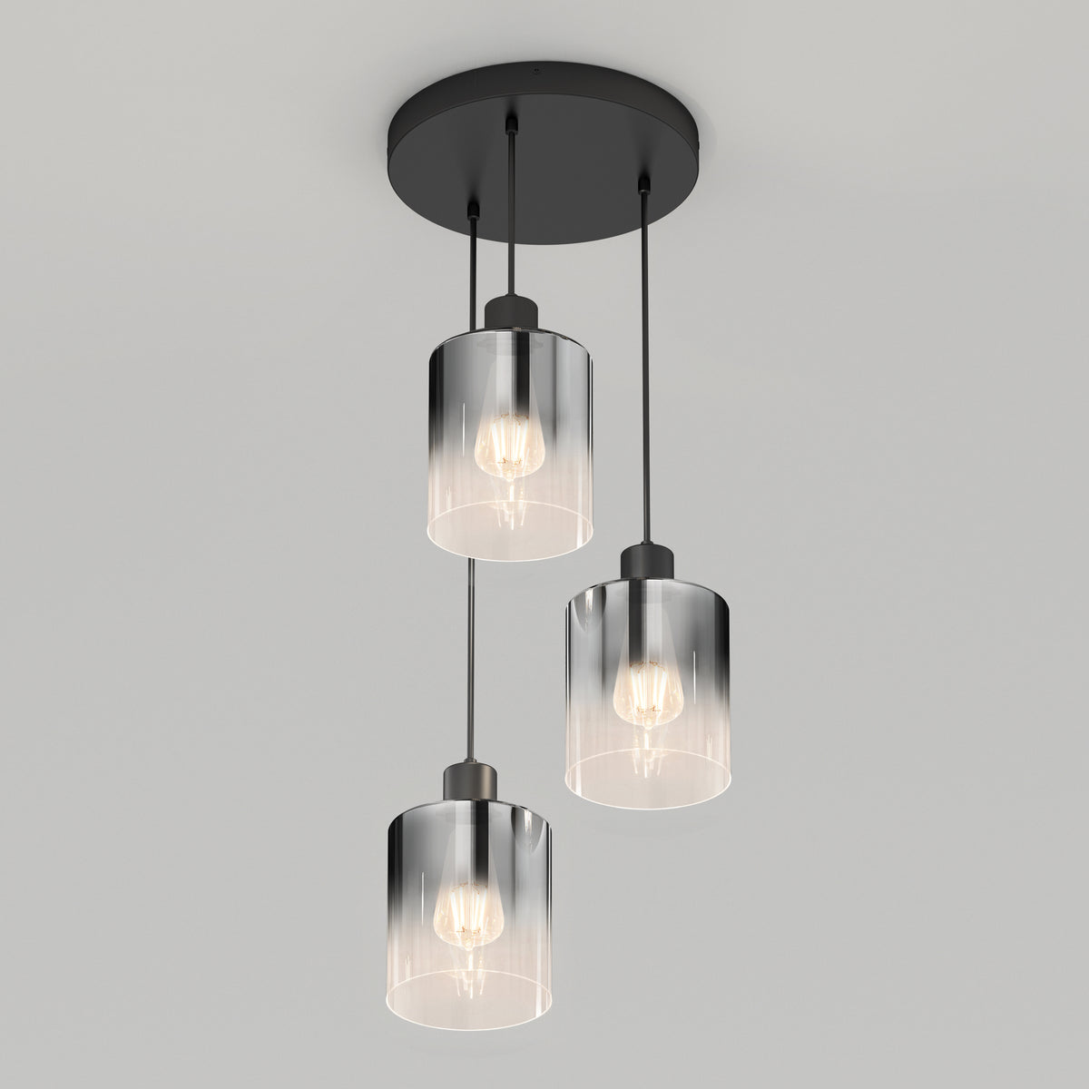 A modern ceiling light fixture with three exposed light bulbs, each encased in a cylindrical glass shade, suspended from a round black base.