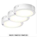 Three round, white LED puck lights are shown in a row on a white background. The set is labeled Pack of 3 / Paquet de 3 in English, French, and Spanish at the bottom of the image.