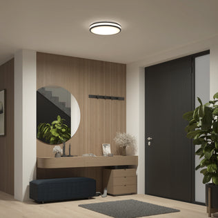 Modern entryway with wood accents, plants, and a black door lit by the Artika Hemisphere 15 in. Modern LED Flush Mount Ceiling Light.