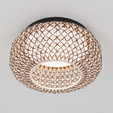 A round ceiling light fixture with a woven, lattice-style rattan shade and a white inner diffuser, mounted on a white ceiling.