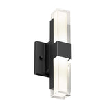 A modern wall sconce with a black rectangular base and two vertical frosted glass light bars extending above and below, emitting soft white light.