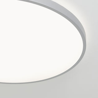 Close-up of Artika's Jupiter 23 in. LED flush mount light with remote, glowing against a white ceiling and offering dimming presets.