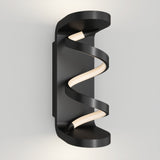 A modern black wall sconce with an LED light strip spiraling vertically between two curved, flat ends, mounted on a light gray wall.