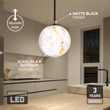 Modern kitchen with a round, marble-like pendant light labeled as having a matte black finish, adjustable height, scagliola diffuser, integrated LED, and a 3-year warranty. No bulbs required.