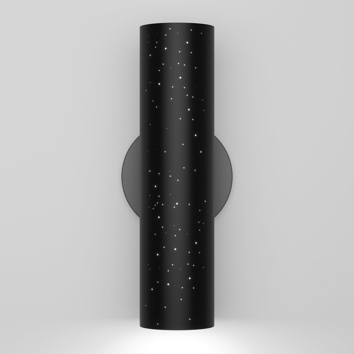 The Artika Cosmic indoor-outdoor LED wall light 3 CCT features a modern black cylindrical design with star-like perforations on a circular base, casting downward light against a plain white wall.