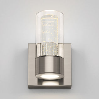 The Artika Essence 1-light LED bathroom vanity light has a brushed metal base and a bubble-detailed cylindrical glass shade.