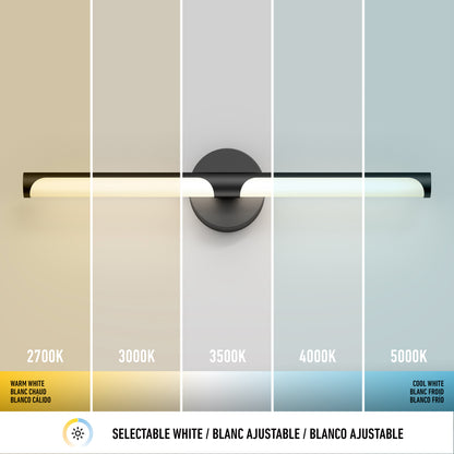 The Artika Ilona LED bathroom vanity light 5 CCT black displays five selectable color temperatures from warm white (2700K) to cool white (5000K) in vertical sections, each labeled, with a white selection icon below.