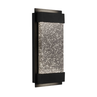 The Artika Essence Glow Box indoor-outdoor LED wall light features a modern rectangular black frame and a clear glass panel filled with sparkling bubbles for a starry, illuminated effect.