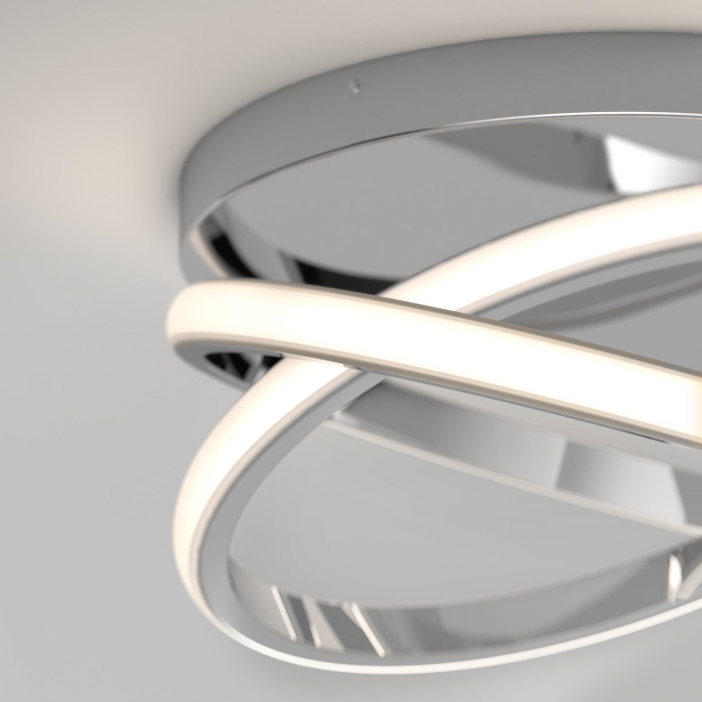 The Artika Orbia modern LED flush mount light 3 CCT features intertwined glowing rings and a metallic circular base, elegantly mounted on a white ceiling.