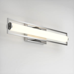 The Artika Rialto modern LED bathroom vanity light 3 CCT features a sleek rectangular chrome frame and cylindrical frosted glass shade, offering dimmable soft white lighting for customizable ambiance on any plain white wall.
