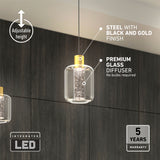 A modern pendant light with a black and gold steel finish, a premium glass diffuser, and integrated LED. The text highlights adjustable height, no bulbs required, and a 5-year warranty. The background features dark wood paneling.