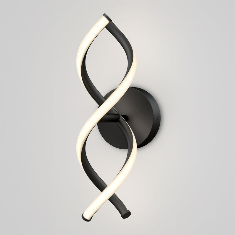 The Artika DNA modern LED wall sconce 3 CCT features two intertwined LED strips—one black, one illuminated—mounted on a round black base against a light gray wall.