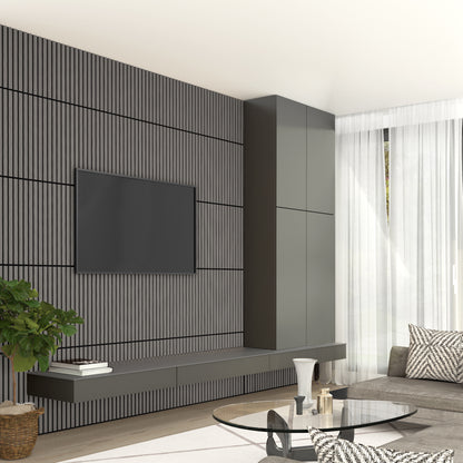 A modern living room features a wall-mounted TV on an Artika Sonolok 15.5 ft sound-absorbing wall panel kit (4-pack) accent wall, floating cabinets, a gray sofa, glass coffee table, potted plant, and sheer curtains letting in natural light.