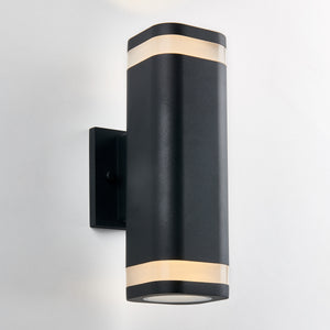 The Artika Mettle LED indoor-outdoor wall light features a modern black design with rounded edges and two frosted bands that emit soft light, shown mounted on a white wall.