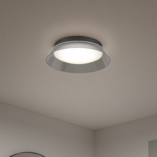 The Artika Arthur modern LED flush mount light 5 CCT features a shiny metallic rim and frosted white cover, mounted on a smooth white ceiling, illuminating a minimalist room.