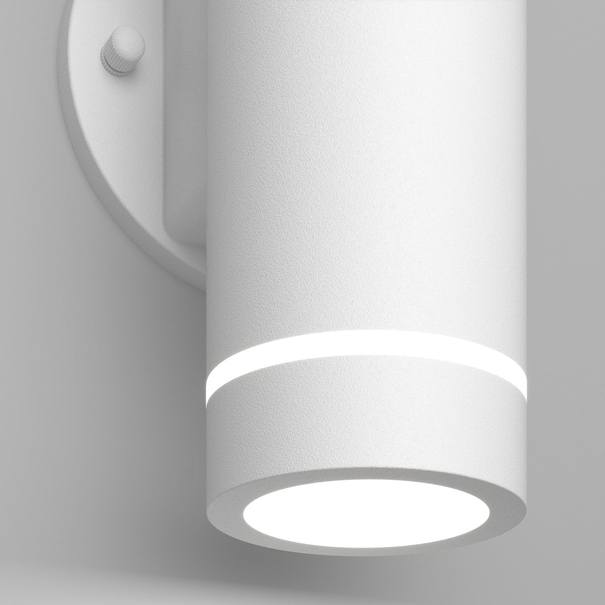 A modern cylindrical white wall light fixture with a subtle glowing ring near the top and a bright circular light at the base, attached to a round wall plate.