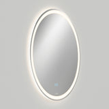 A round wall-mounted mirror with an illuminated LED light ring around its edge, set against a plain light gray background. Two small blue touch buttons are visible at the bottom center of the mirror.