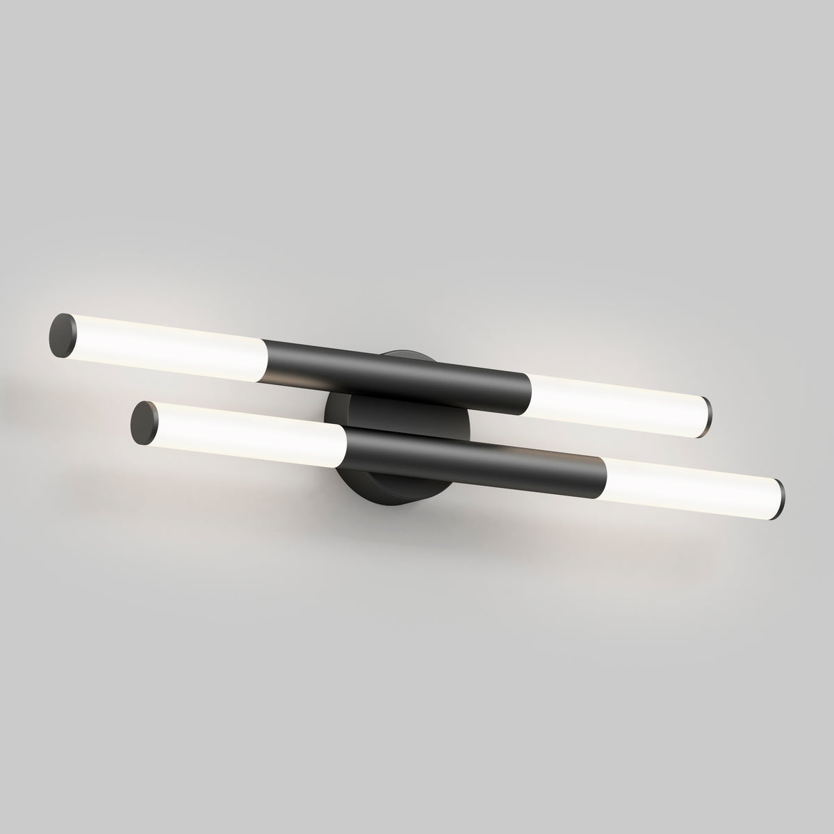 Modern wall sconce with two horizontal, parallel black bars, each featuring cylindrical white light tubes at both ends, mounted on a round black base against a light gray background.
