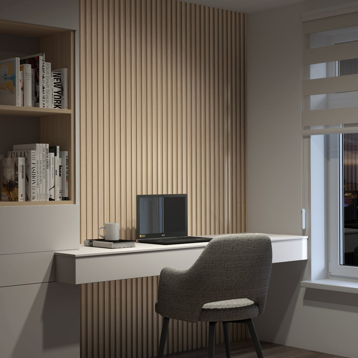 A modern home office with a gray chair, white floating desk, closed laptop, mug, and notepad. The wall features Artika's Panolok 30.67 ft wall panel kit (pack of 8), shelves with books, and a window with beige blinds showing evening light.