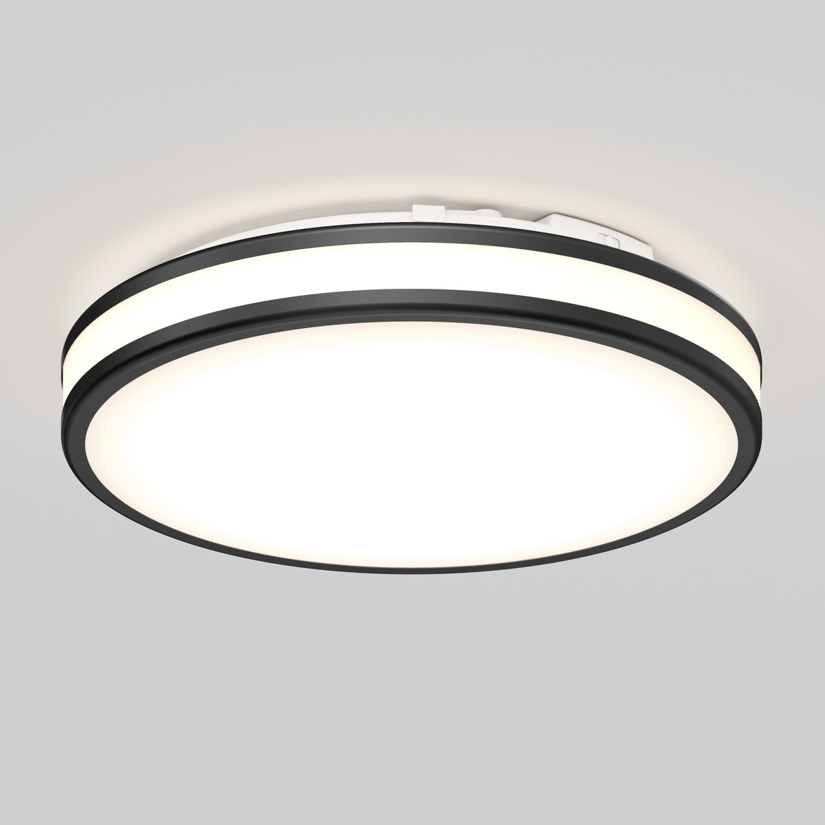 The Artika Hemisphere 15 in. LED flush mount light features a black outer ring, bright white center, and 5 selectable color temperatures. Adjustable brightness makes it ideal for stylish bathroom lighting on a light gray ceiling.