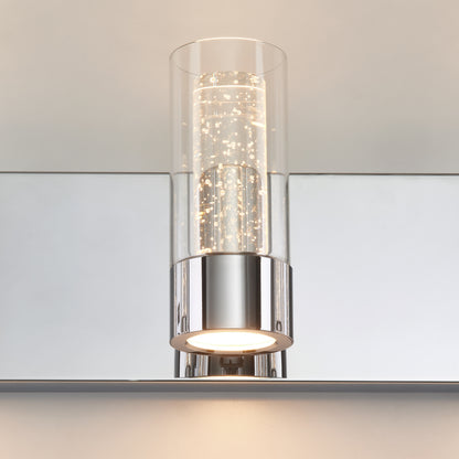 Artika Essence 27-in LED vanity light features a modern chrome base and glass shade—ideal for mounting above bathroom mirrors.