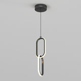 A modern pendant light fixture with two interlocking oval LED rings hanging vertically from a black ceiling mount against a plain gray background.