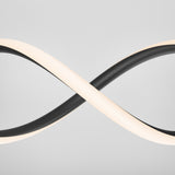 A modern light fixture with two intertwined, looping bands—one black and one illuminated white—set against a plain light gray background, forming an infinity symbol shape.