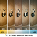 A modern wall sconce is shown under five different white light temperatures, ranging from warm (2700K) to cool (5000K), demonstrating the effect of selectable white lighting on a wooden wall.
