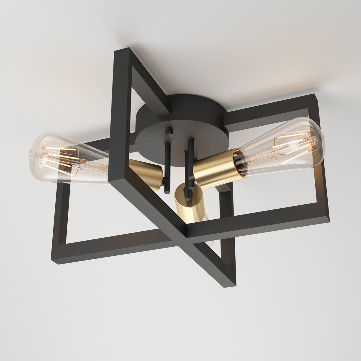 Modern ceiling light fixture with intersecting black metal frames, two exposed Edison bulbs, and brass accents, mounted on a white ceiling.
