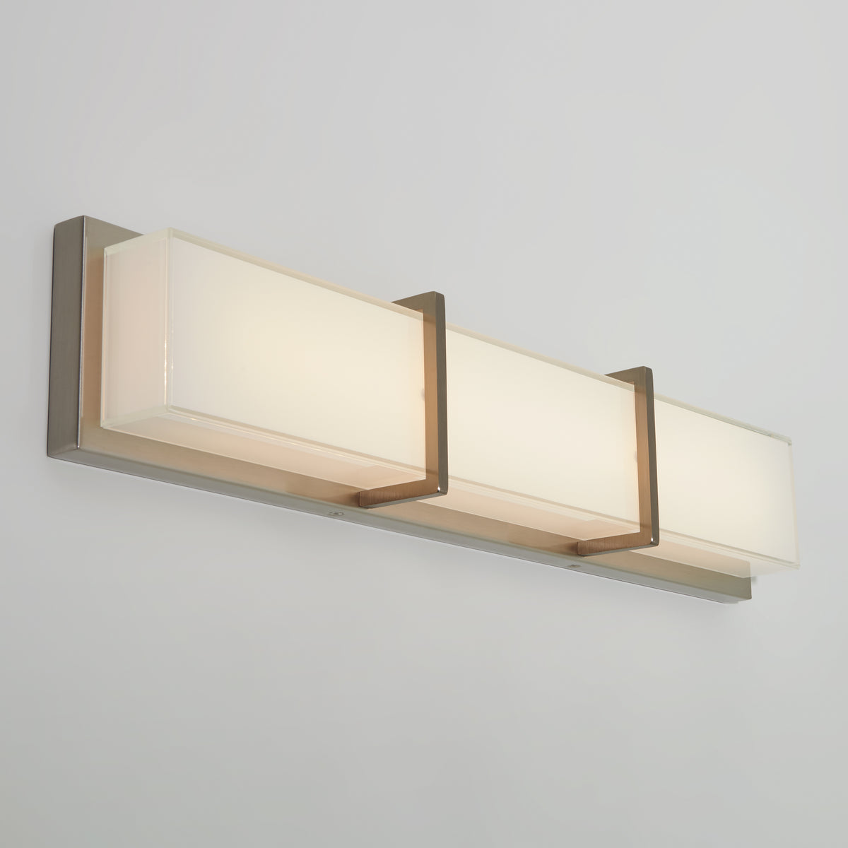 Artika Subway modern LED bathroom vanity light features three frosted glass shades and a brushed metal base for stylish bathroom lighting.