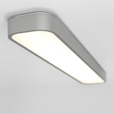 A modern, rectangular ceiling light fixture with a smooth silver frame and a bright, evenly lit white panel, mounted on a white ceiling.