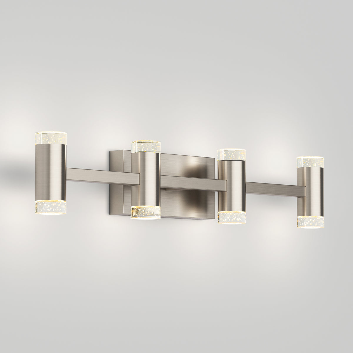 The Artika Mist modern LED bathroom vanity light 5 CCT features four cylindrical lights with a brushed nickel finish and clear, textured end caps, providing adjustable colour balance and stylish illumination for your bathroom.