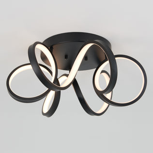 The Artika Swirl Ribbon flush mount light features three intertwined LED loops in black, mounted on a round black base, emitting a soft white glow against a light gray background.