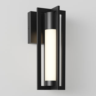 The Artika Walt indoor-outdoor LED wall light features geometric rectangular metal framing and a cylindrical white frosted glass shade, creating a sleek, contemporary look when mounted on any plain white wall.