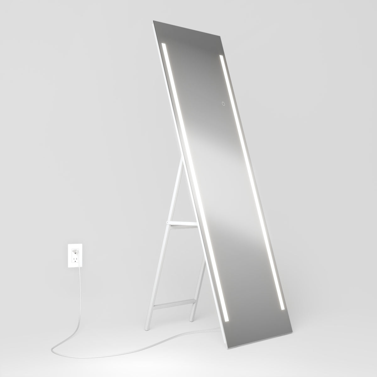 The Artika Emeraude 19"x59" full-length floor mirror features built-in vertical LED lights and stands on a white easel, plugged in.