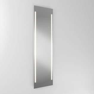 The Artika Emeraude 19"x59" full-length floor mirror features vertical LED lights, mounted on a plain white wall.