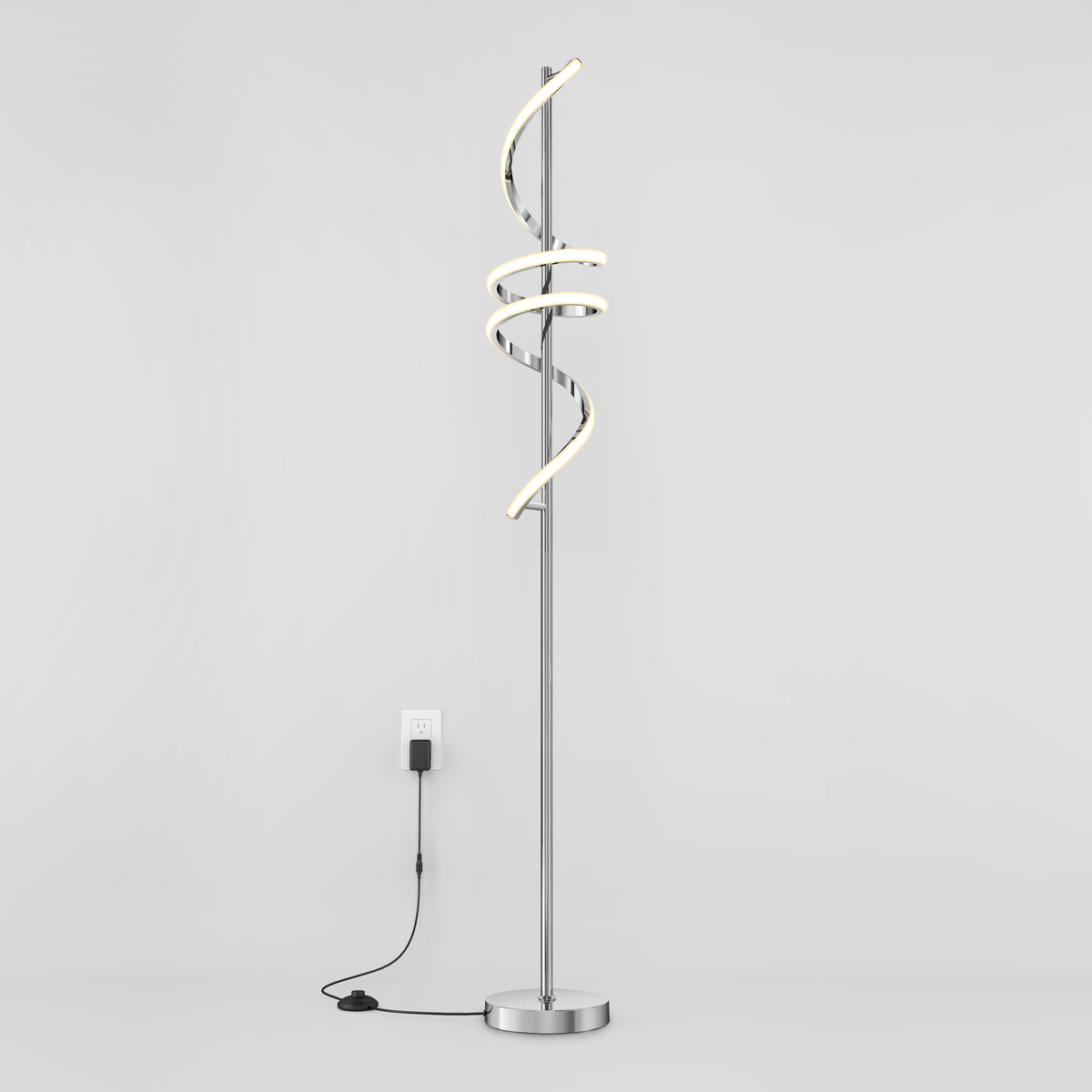 The Artika Coda modern LED floor lamp 5CCT features a spiral design, dimmable lighting, and stands on a round base with a visible black cord and switch, shown plugged in against a plain white background.