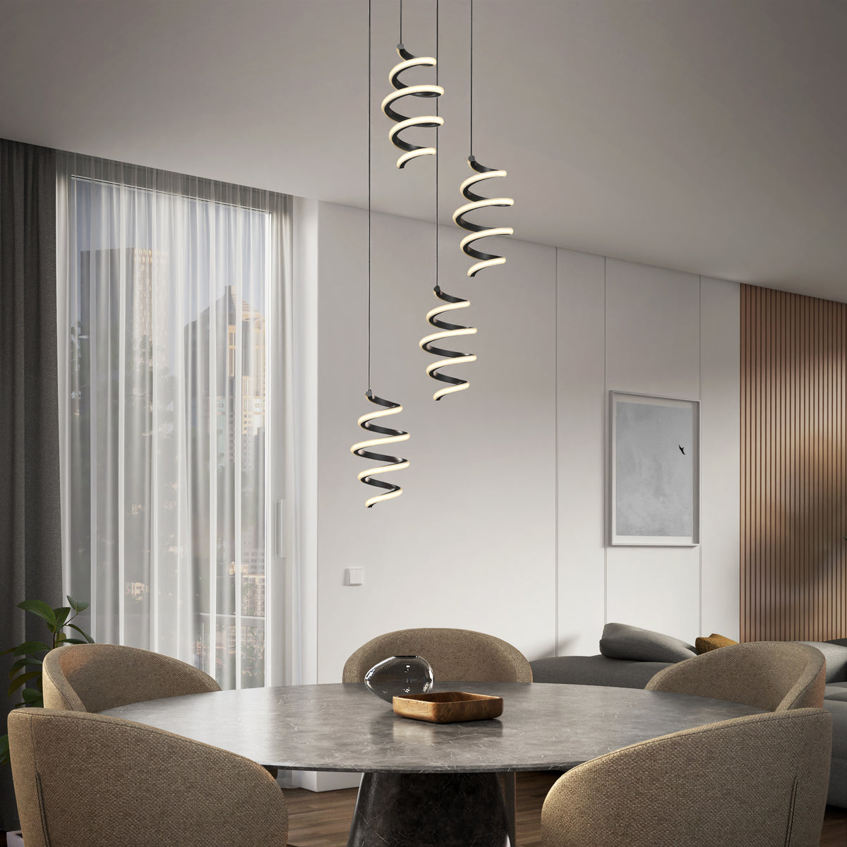 A modern dining room with a round table and four beige chairs, featuring three spiral pendant lights hanging above. Large window with sheer curtains and city view, minimalist decor, and a wooden accent wall.