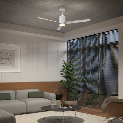 A modern living room featuring a gray sectional sofa, round black coffee table, potted plant, large windows with blinds, abstract wall art, and the Artika Ellison 52 in. LED modern ceiling fan with remote.