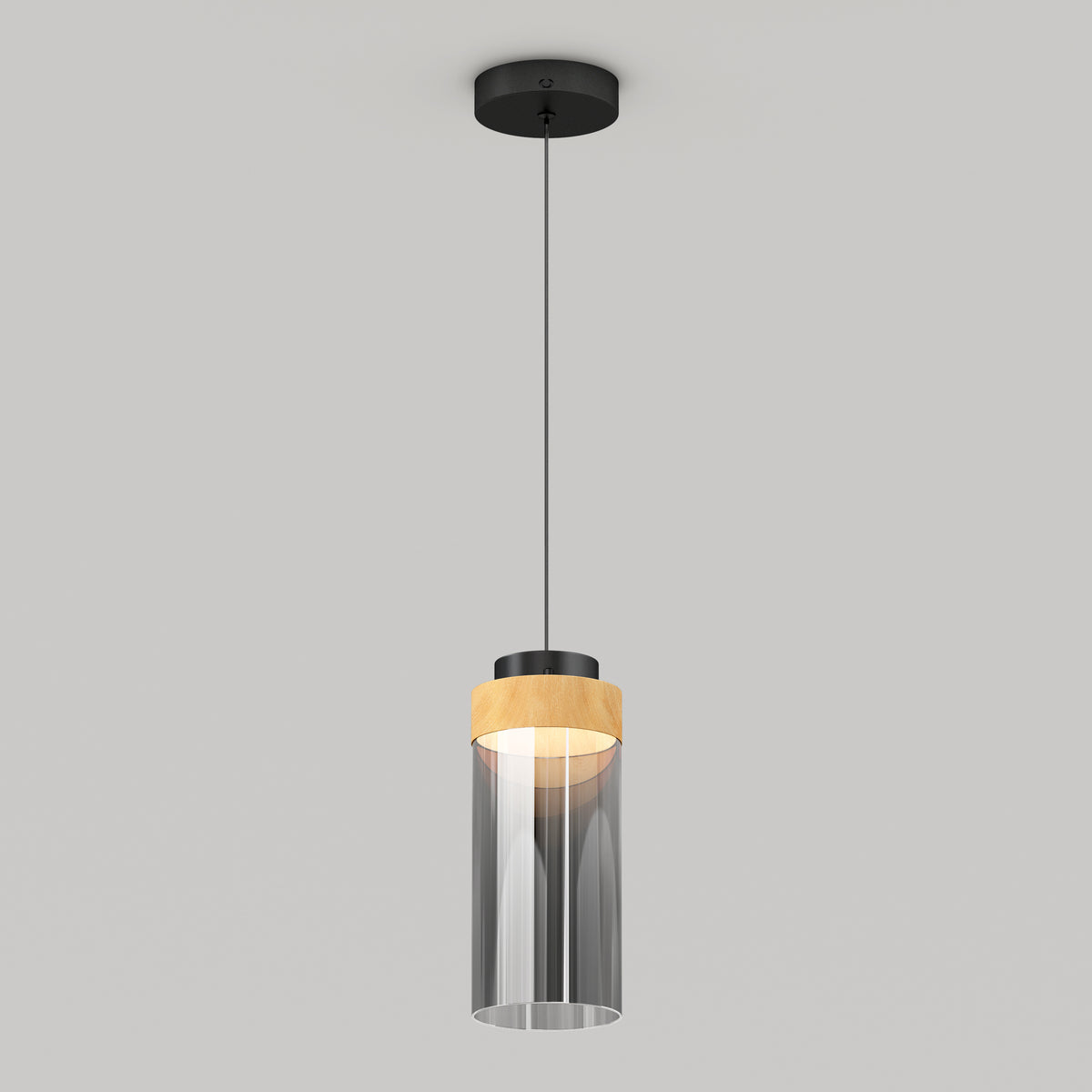 The Artika Hanson 1-light LED pendant 5 CCT features a black ceiling mount, black cord, cylindrical glass shade with a wooden accent on top, and emits a soft glow when illuminated.