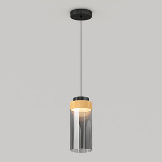 The Artika Hanson 1-light LED pendant 5 CCT features a black ceiling mount, black cord, cylindrical glass shade with a wooden accent on top, and emits a soft glow when illuminated.