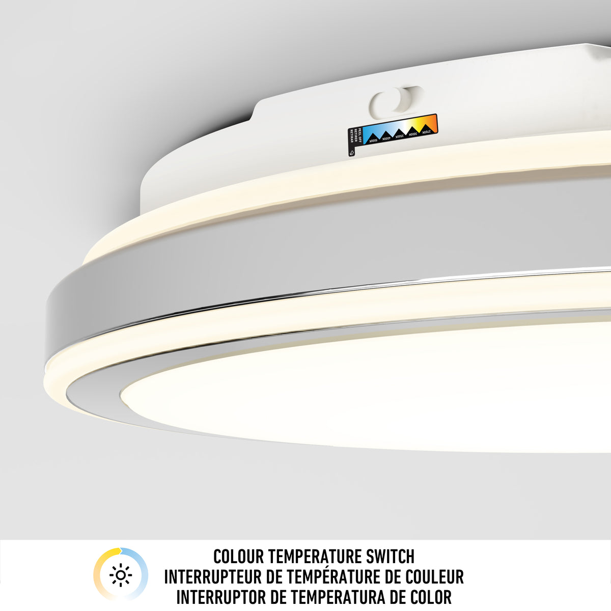 A close-up of a ceiling light fixture with a color temperature switch labeled with different color levels. Text below reads: Colour Temperature Switch in English, French, and Spanish.