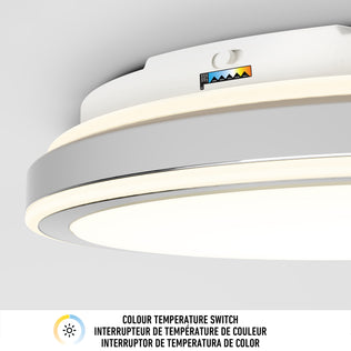 A close-up of the Artika Altitude 15 in. LED modern flush mount light 5 CCT, showing its adjustable colour temperature slider above a multicolored scale. Text below says "COLOUR TEMPERATURE SWITCH" in English, French, and Spanish.
