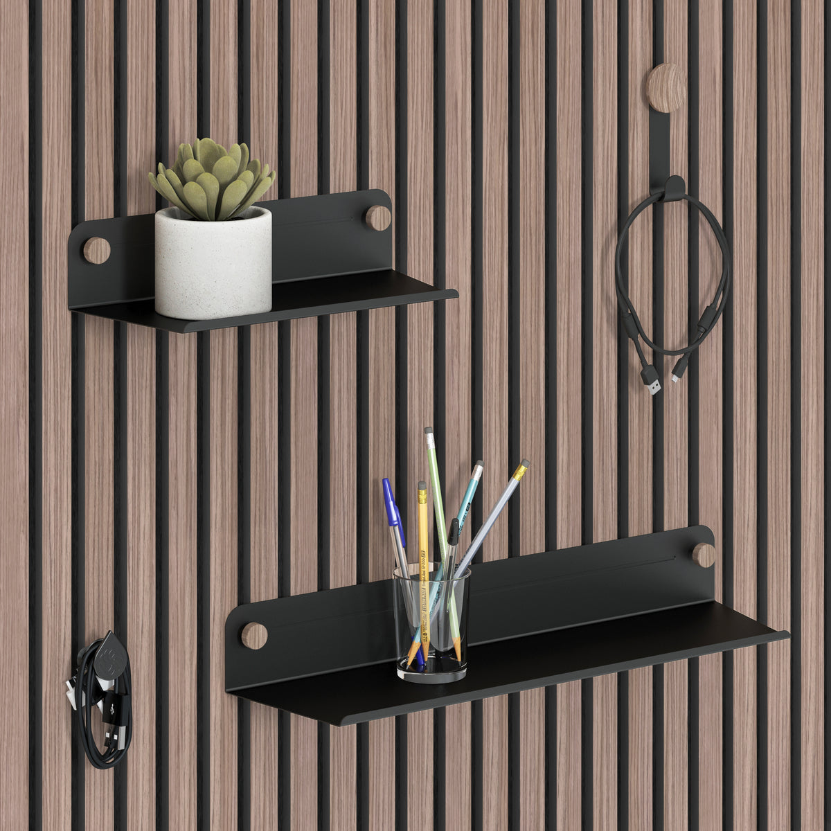 The Artika Sonokit set of shelves and hooks for Sonolok and Sonofold wall panels holds a potted succulent, pens, charging cable, and headphones. Enjoy quick installation and an organized workspace with this versatile storage solution.