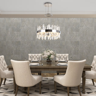 Elegant dining room with a wooden table for six, beige upholstered chairs, Artikas Enchanted LED pendant light as the centerpiece, neutral textured wallpaper, and a floral arrangement on the table.
