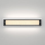 A modern rectangular wall light fixture with a frosted glass cover and black end caps, mounted on a light gray wall and emitting a warm, even glow.