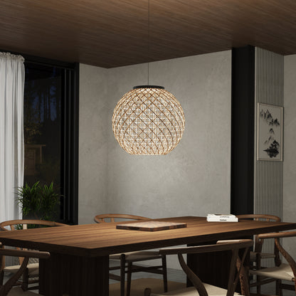 A modern dining room features a large wooden table, matching chairs, and the Artika Benson LED pendant light 5 CCT hanging above. The space is completed with neutral walls, a wooden ceiling, a plant, and framed art.