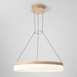 A modern pendant light with a round wooden frame and white diffuser, suspended from the ceiling by three black cables attached to a circular wooden ceiling mount. The design is minimal and contemporary.