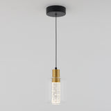 A modern pendant light with a black ceiling mount, a black cord, a gold fixture, and a cylindrical clear glass shade surrounding a textured inner diffuser.