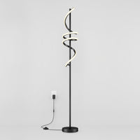 The Artika Coda modern LED floor lamp 5CCT features a black stand with three spiral LED light tubes, dimmable for customizable ambiance, standing against a white wall and plugged into a wall outlet.